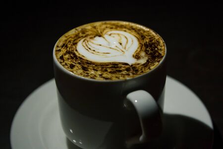 cup of coffee on table at night timeの写真素材