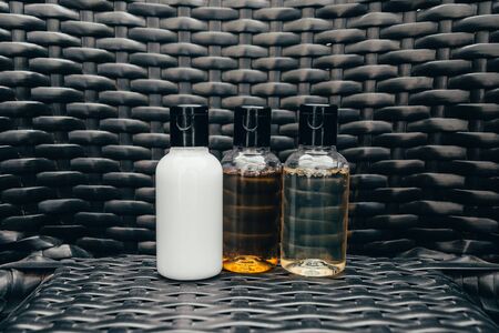 close up view of shower gel, shampoo and body lotion in small travel tubes in hotel bathroom