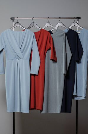 new stylish dress collection on the hangers of clothing rack rails. fashion design studioの写真素材