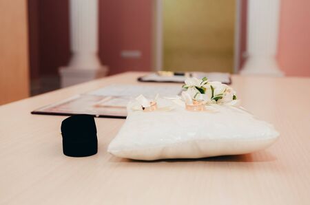 wedding rings on little decorated pillow in registry office. wedding moments backgroundの写真素材