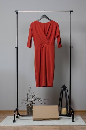 New red dress on hanger on garment rack in fashion design studio with empty copyspace for writing your brandの写真素材