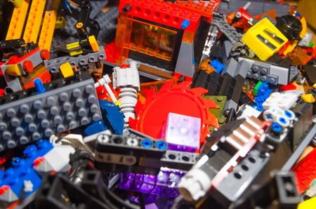 colored toy bricks for kids on the floor. background of plastic pieces and elements of constructor toysの写真素材