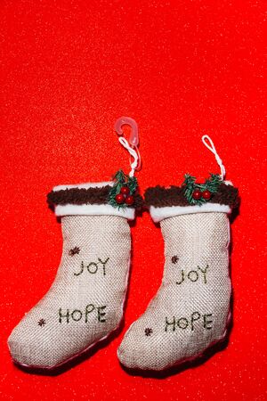 christmas stocks on red background with written Joy and Hopeの写真素材