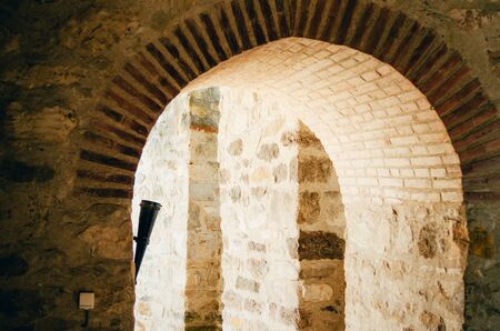brick walls of inside room with an arch in acient castleの写真素材