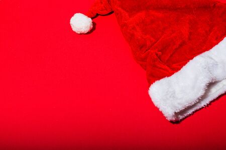 flat lay santa claus hat isolated on red backgroundの写真素材