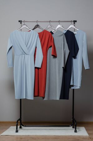 new stylish dress collection on the hangers of clothing rack rails. fashion design studioの写真素材