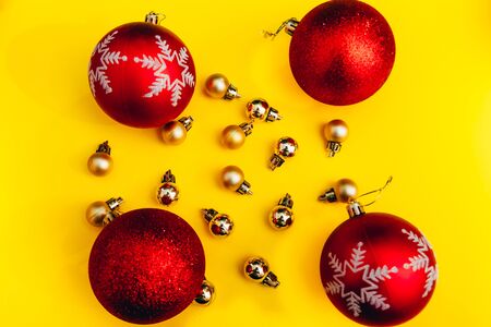 flat lay christmas tree balls from tpo view.  a square of yellow and red new year decorations backgroundの写真素材