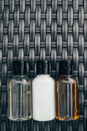 shower gel, shampoo and body lotion in small tubes. travel bottle set mock upの写真素材