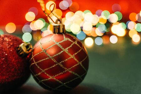 two red christmas tree balls with bokeh lights on background. fairy ans magical christmas moodの写真素材