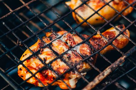 close up view of frying delicious chicken leg on the brazier at the picnic outsideの写真素材