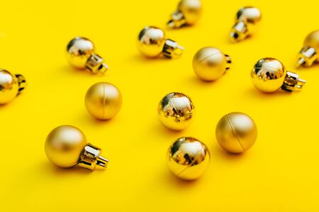 flat lay of golden christmas tree balls background. new year decoration in yellow colorの写真素材