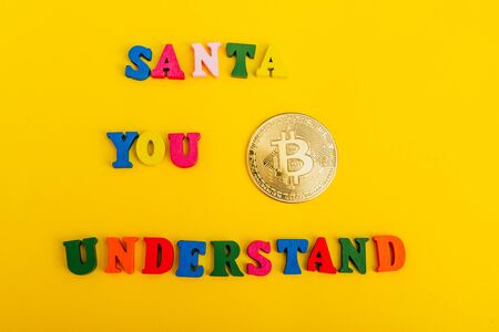 asking santa for money. bitcoin is a cryptocurrencyの写真素材