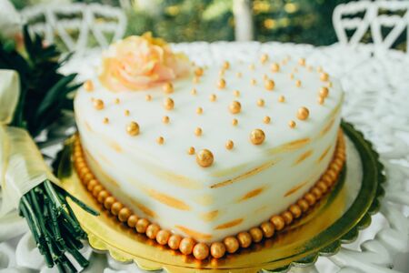 wedding white cake in the shape of a heart decorated with flowersの写真素材