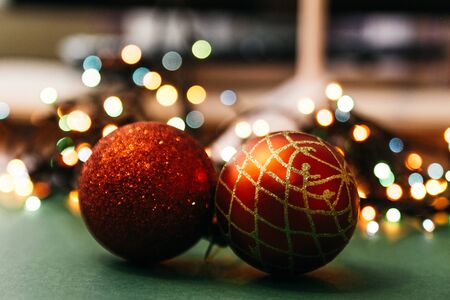 two red christmas tree balls with bokeh lights on background. fairy ans magical christmas mood....