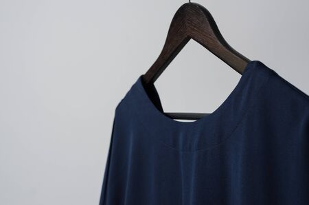 close up view of black female dress on hanger with isolated background. new collection of office clothes from sewing factory designed in fashion studioの写真素材
