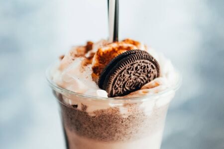 close up view of cookie on top of shake. cooling drinks in local coffee shop
