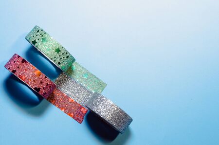 colorful and shiny washi tapes isolated on blue background