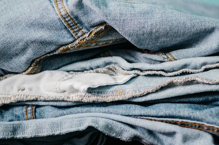 denim clothes in a pile. washed jeans concept . background