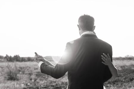 black and white photo of a love couple dancing during sunsetの写真素材
