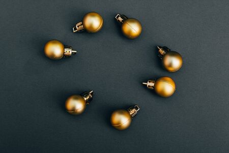 flat lay of golden christmas tree . new year decoration in yellow color on black background .の写真素材