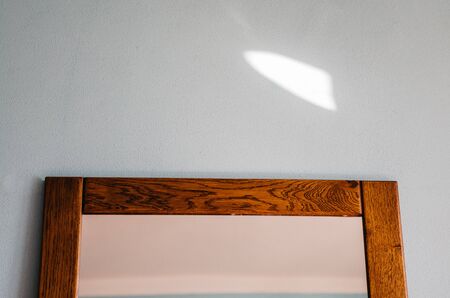 close up of mirrow in the bedroom on the blue wall. minimalism of interior of the room