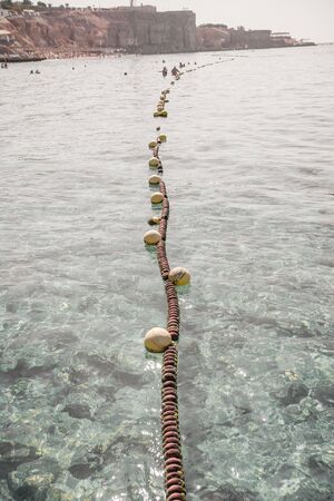 line of buoys at the sea.  safety at the beach concept