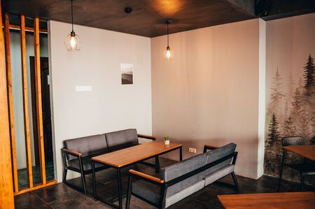 coffee shop interior. table with black soft sofasの写真素材