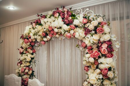 arch with flowers on wedding day in the restaurantの写真素材