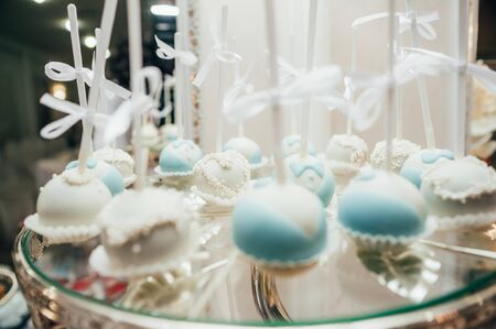 blue and white pop cakes on wedding candy bar table. selective focusの写真素材