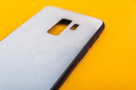broken phone case isolated on yellow background