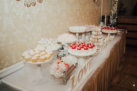 candy bar table with sweets and pop cakes on a holiday