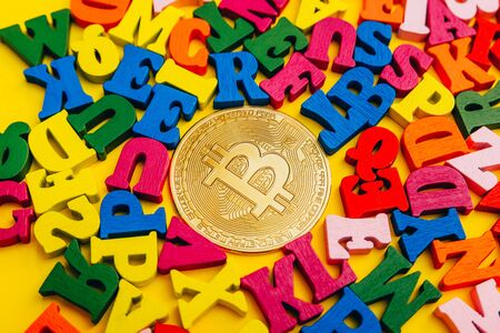 bitcoin on small colorful  wooden letters from top view.  Crypto currency concept.の写真素材