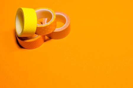 colorful washi tapes isolated on yellow background. top view. flat lay. Feminine stationeryの写真素材