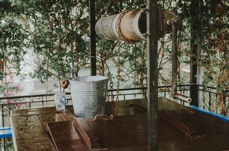 Old water well in the garden. draw well in european village. country side lifestyleの写真素材