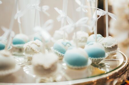 blue and white pop cakes on wedding candy bar table. selective focusの写真素材