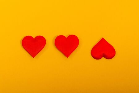 flat lay of colorful hearts isolated on yellow  background. A symbol of love. be differentの写真素材