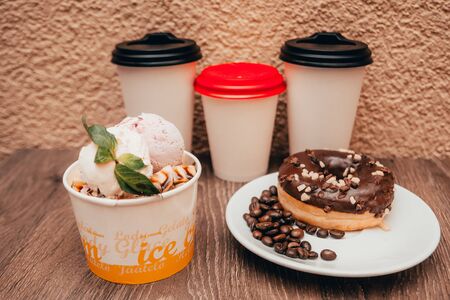 takeaway coffee cup and coffee beans , ice cream . breakfast at the coffee shop conceptの写真素材