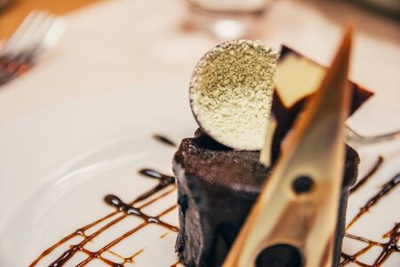 beautiful chocolate cake on the plate with choco decor  in restaurantの写真素材