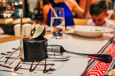 beautiful chocolate cake on the plate with choco decor  in restaurantの写真素材