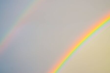 two rainbows in the sky after rainの写真素材