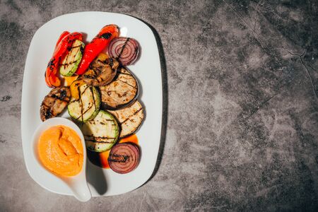 grilled vegetables on  plate with sauce from the top viewの写真素材