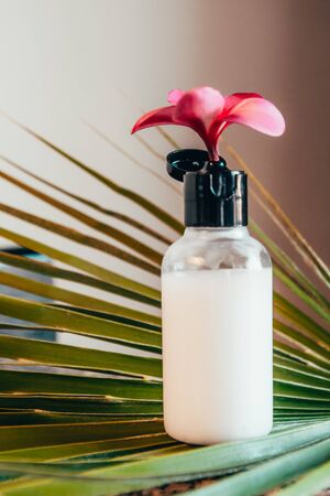 white hotel bath tube with exotic flowers . travel bottle set mock up
