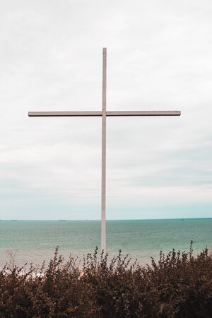 big cross with sea on the background. religion conceptの写真素材