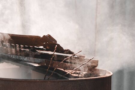 a barrel of garbage burns and smokes . pollution conceptの写真素材