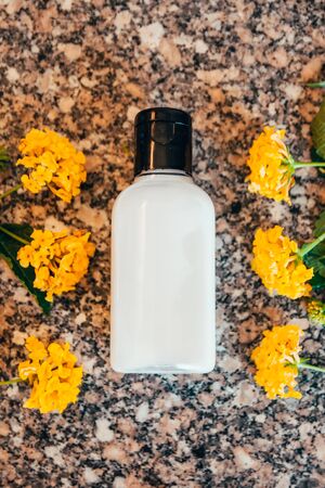 white hotel bath tube with yellow exotic flowers . travel bottle set mock upの写真素材
