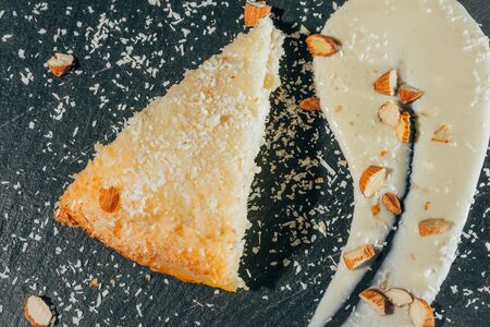 cake with almonds and coconut shvings on top . close up top view .の写真素材