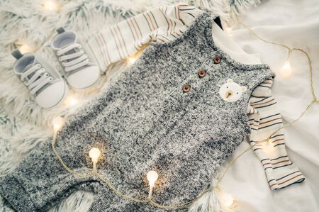 gray children's costume and sneakers  for a newborn baby. parents expect baby's birth . top view .の写真素材