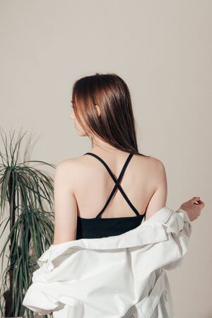 sexy back of a beautiful girl in a black dress with an open back .の写真素材