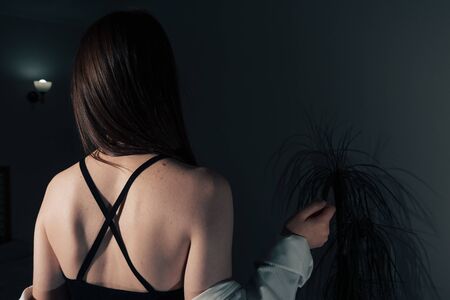 sexy back of a beautiful girl in a black dress with an open back .の写真素材