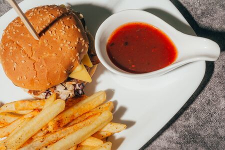 a hamburger with french friesand sauce for restaurant menu with copyspaceの写真素材